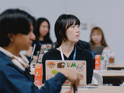 Student with laptop listening to someone off camera