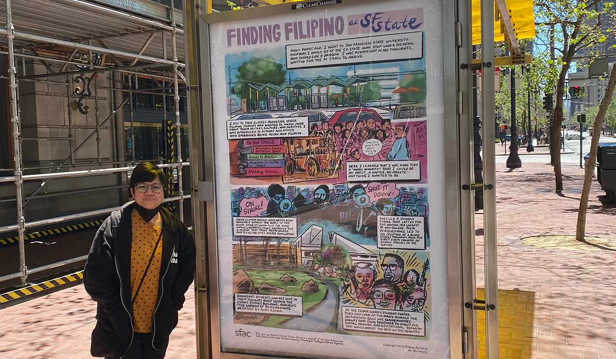 Rina Ayuyang stands next to her “Finding Filipino at SF State” poster at a bus shelter on Market Street in downtown San Francisco on a sunny day