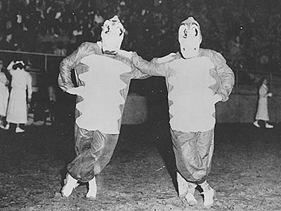 Black and white photo of two old gator mascots
