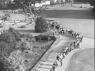 Black and white photo of a line of students in quad