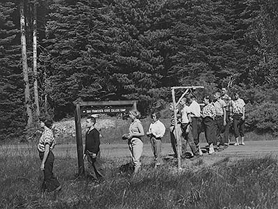 Black and white photo of children lined up by San Francisco State Collge Camp sign