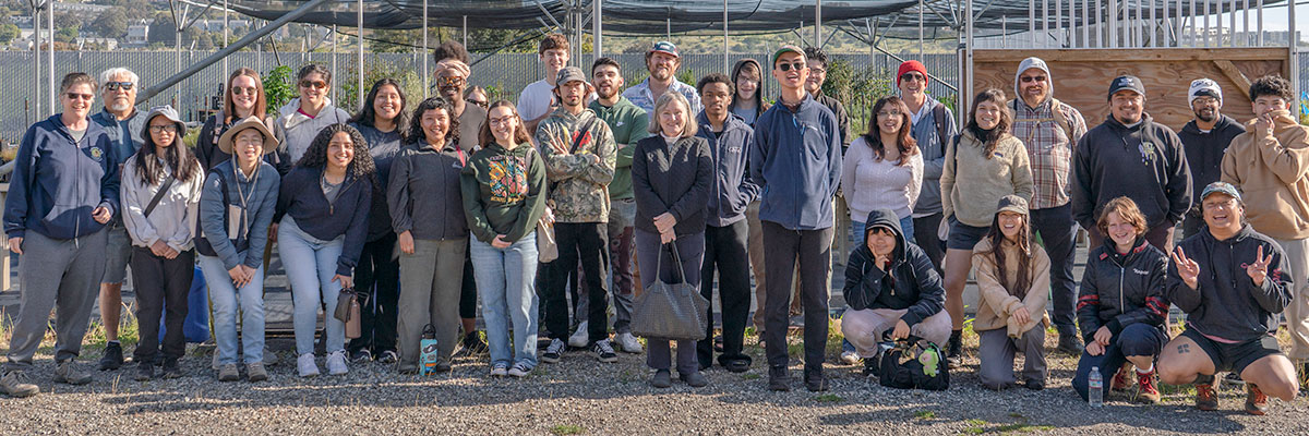 Group photo of 40 people smiling at the camera