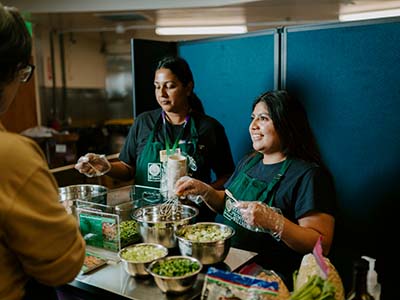 Two women doing a cooking demo