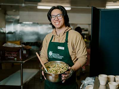 Man presenting a pasta salad in a bowl