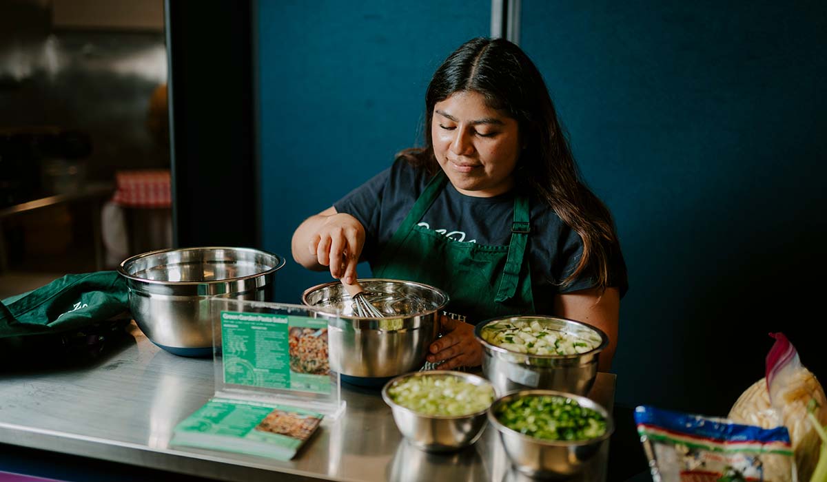 Woman whisking salad dressing