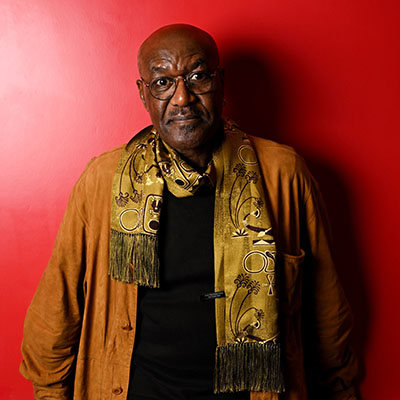 headshot of Delroy Lindo wearing a scarf