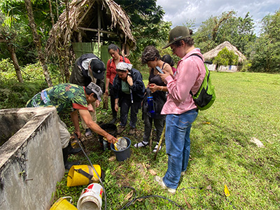 Students listening to a coffee farmer demonstration
