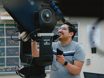 Gabriel adjusting a microscope