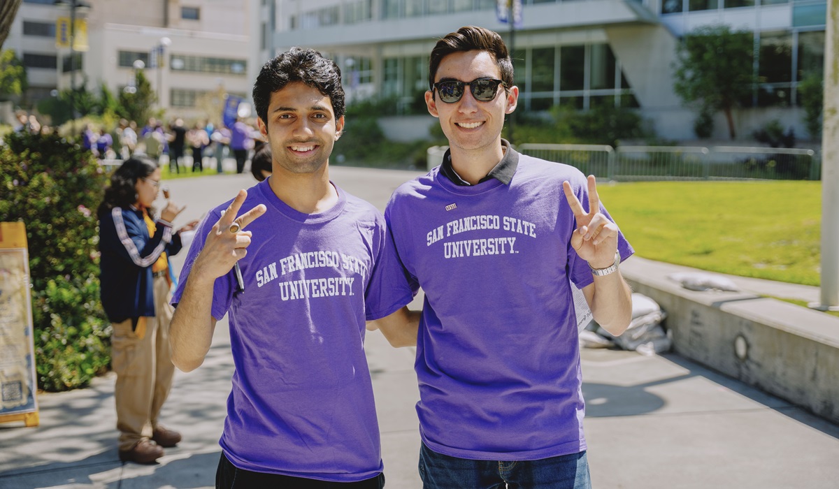 Two smiling students in SFSU t-shirts