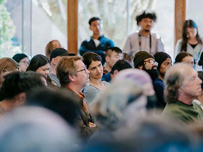 Students and faculty listening to speaker