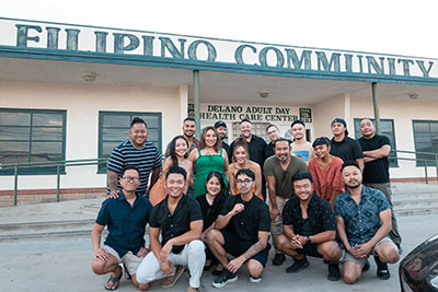 Cast and crew poses in front of the community center 