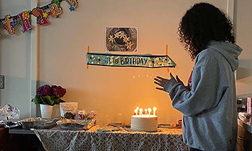 Berenice Baca clapping at a birthday cake