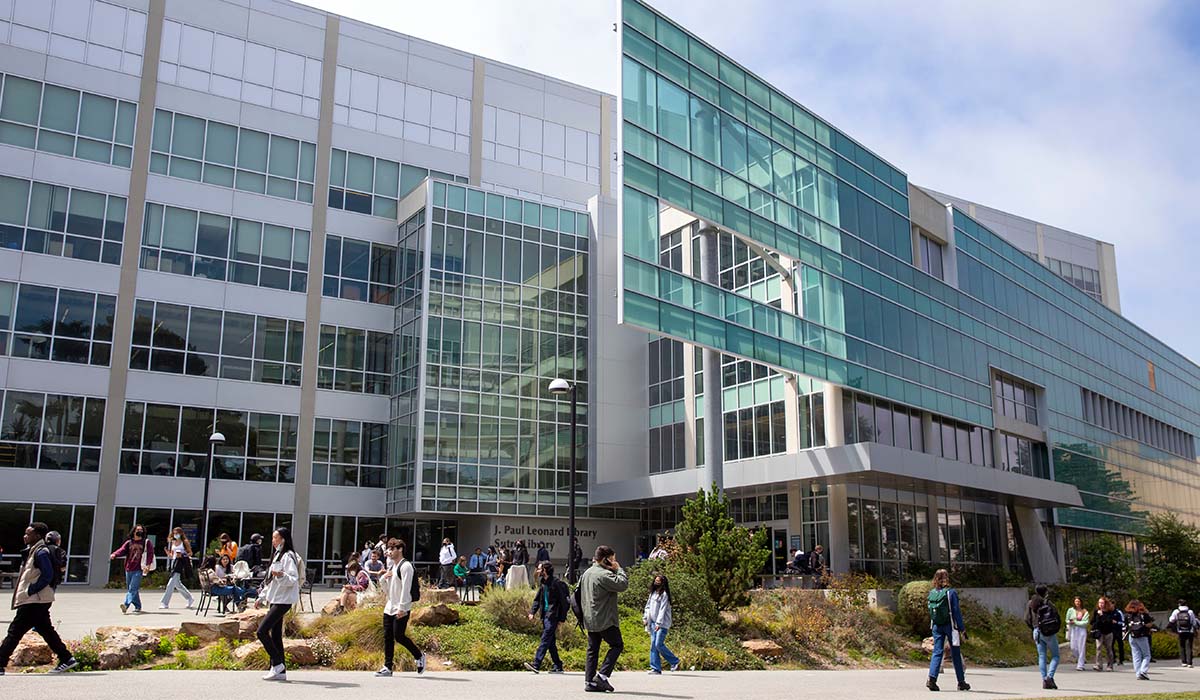 Students walking in front of library