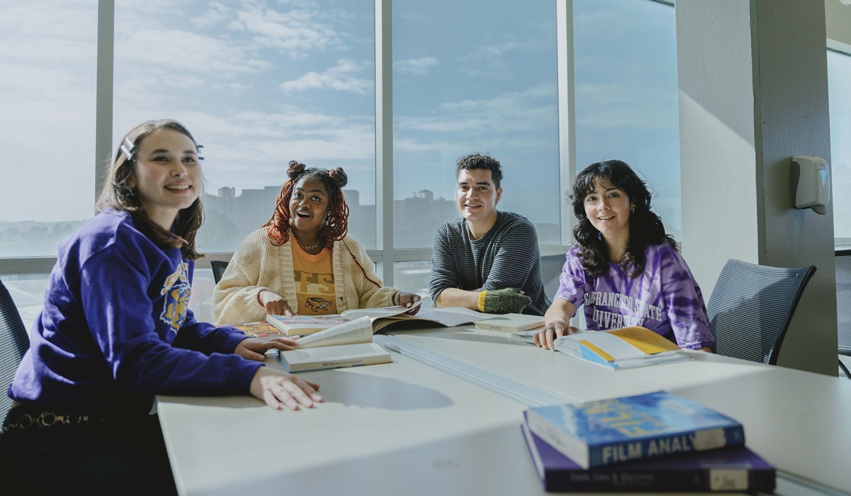 Four students sit at a table