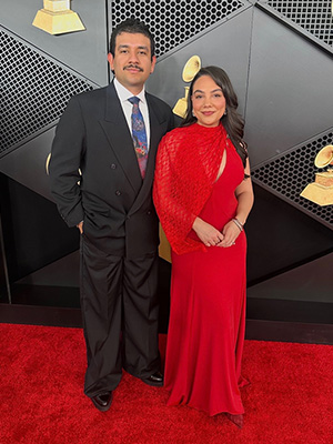 Zach Pereyra and Mackenzie Guthrie pose for a photo on the red carpet of the 2026 Grammy Awards