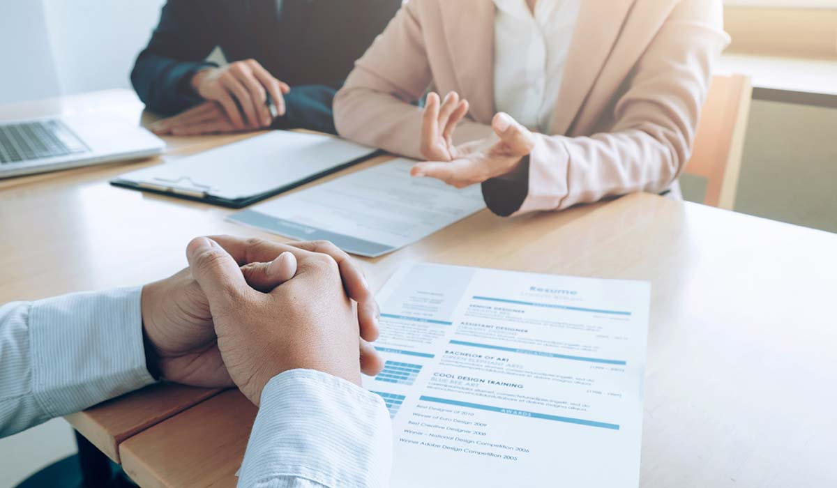 Hands of three people in a job interview