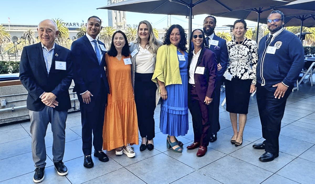 Men and women smile at the Guardian Scholars luncheon