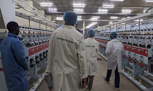 Students walking through a manufacturing plant