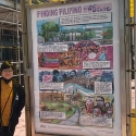 Rina Ayuyang stands next to her “Finding Filipino at SF State” poster at a bus shelter on Market Street in downtown San Francisco on a sunny day