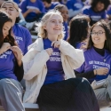 Students in SFSU T-shirts sit together on stadium bleachers