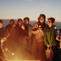 Students with marshmallows on sticks around a bonfire