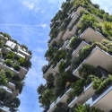 Two tall buildings with plants incorporated in its design