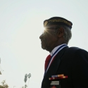 Henry Charles Johnson, a veteran and member of the Montford Point Marines, walks outdoors in uniform on a sunny day