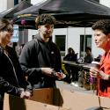 SF State President Lynn Mahoney (right) speaks with a family in front of the newly built West Grove Commons residence hall. Photo by Kevin Perez.