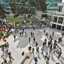 Aerial view of a university campus quad with a crowd of students walking through it.