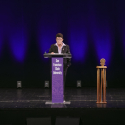 Lynn Mahoney speaking at a podium