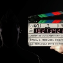 A person holds a film slate for Veteran Documentary Corps