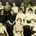 A group of women pose together in an old photograph