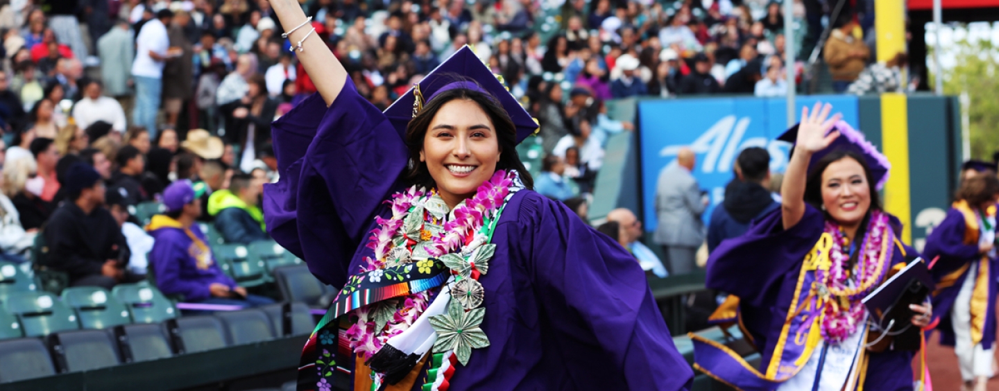 SF State graduate walking through Oracle Park