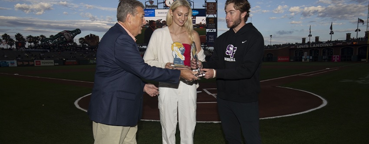 A man presents Cameron Brink and Garrett Jensen with awards at Oracle Park