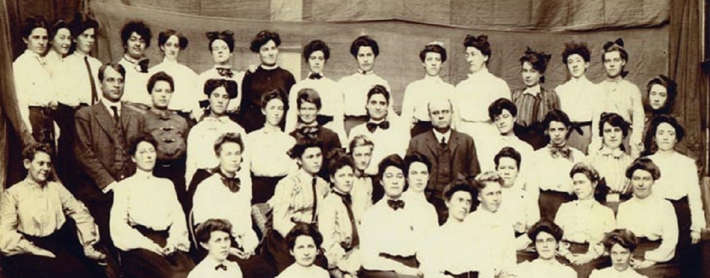 A group of female students and two male instructors circa 1906