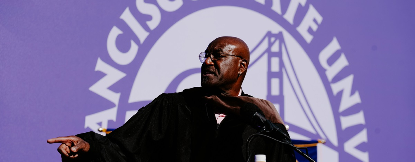 Delroy Lindo gestures on stage at Commencement