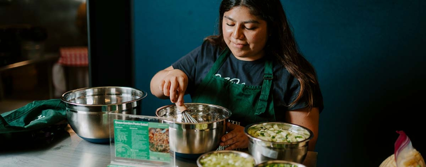 Woman whisking salad dressing