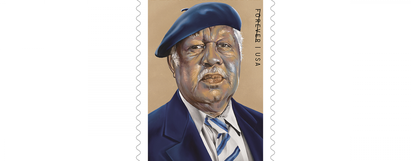 Ernest J. Gaines’ USA forever stamp for the Black Heritage Series shows an illustration of him wearing a blue beret, blue suit jacket, white-collar shirt and striped tie