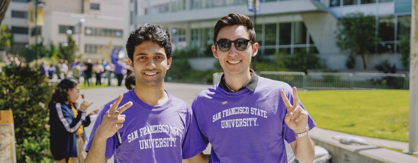 Two smiling students in SFSU t-shirts