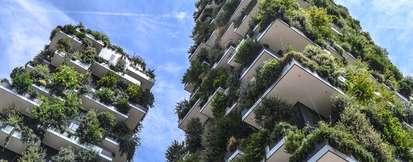 Two tall buildings with plants incorporated in its design