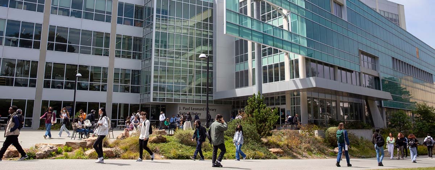 Students walking in front of library