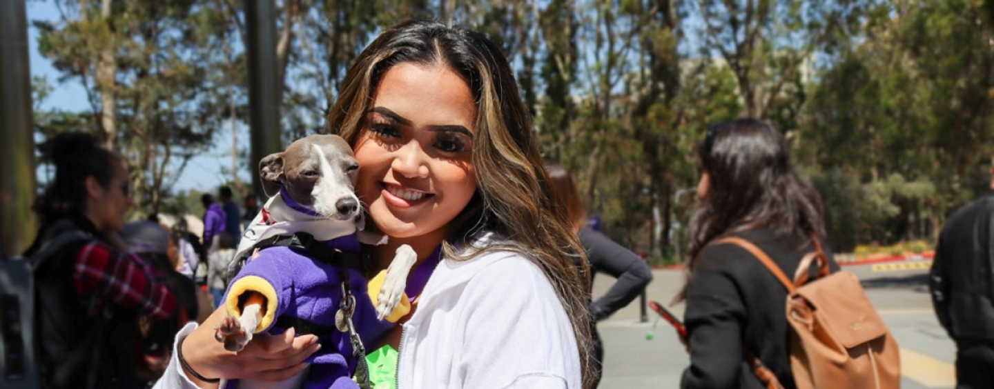 A woman holds a dog