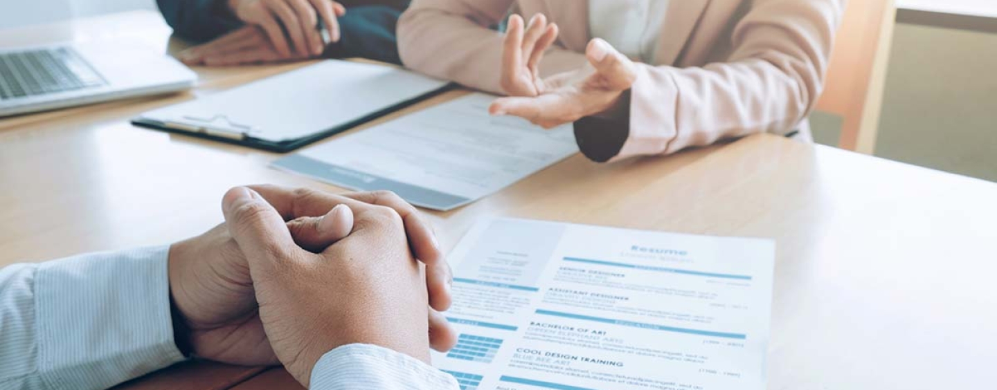 Hands of three people in a job interview