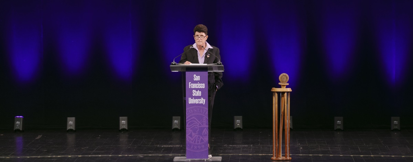 Lynn Mahoney speaking at a podium