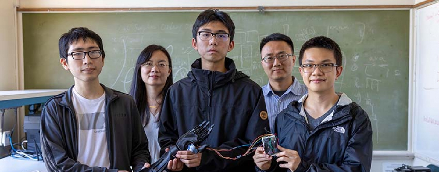 Students and faculty with bionic arm and Sony microprocessor