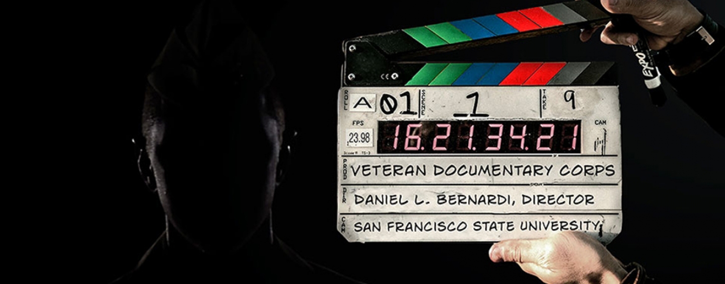 A person holds a film slate for Veteran Documentary Corps
