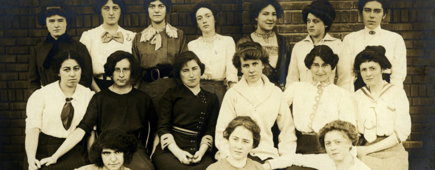 A group of women pose together in an old photograph