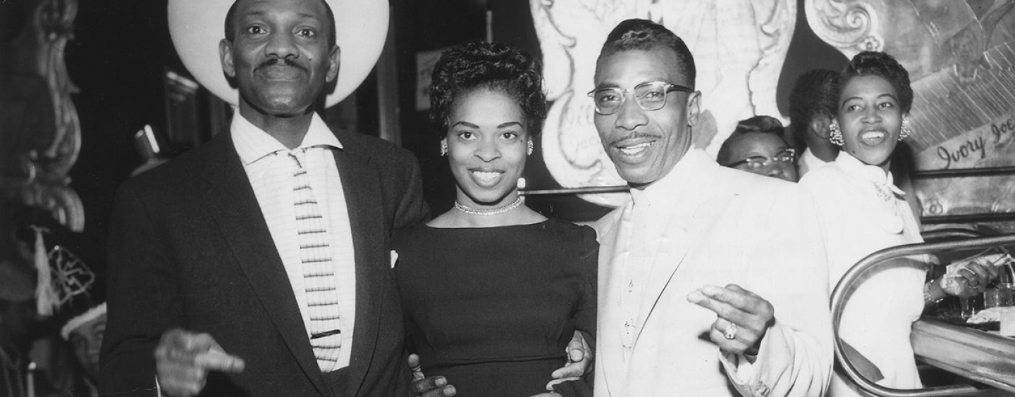 Wesley Johnson, a woman and blues musician T-Bone Walker pose for a picture while standing inside the Texas Playhouse nightclub