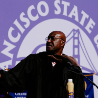 Delroy Lindo gestures on stage at Commencement