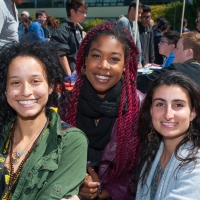 Three students smile at the camera